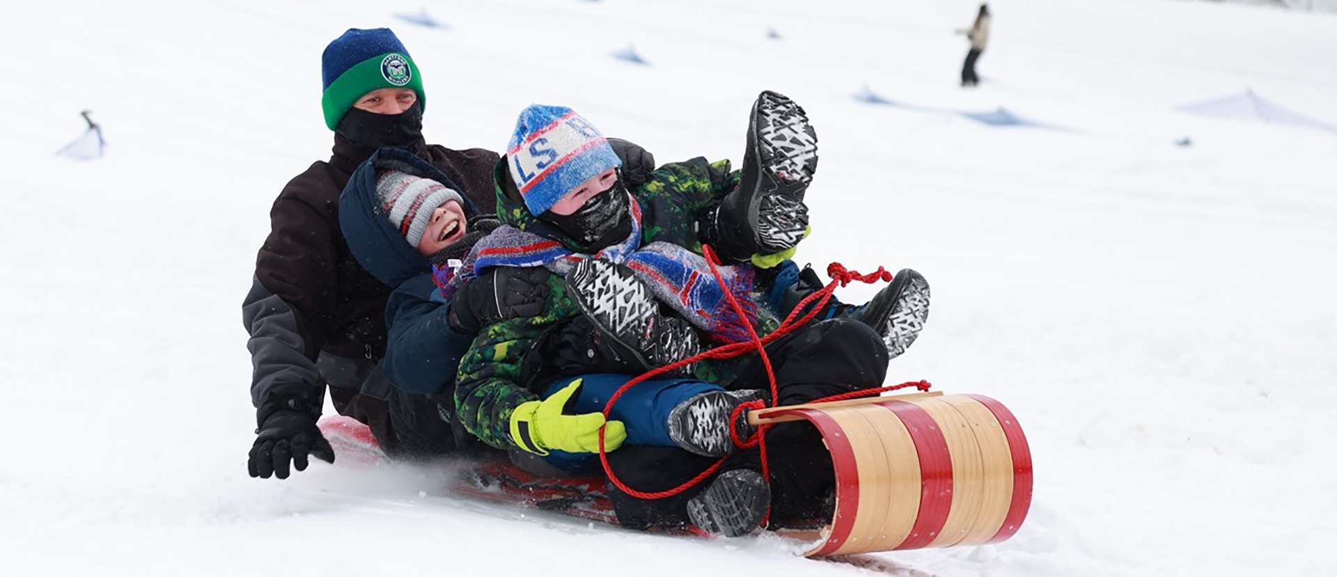 Nick Bado, left, of Tonawanda, and his son Everett, 10, center, and his friend Liam O’Connor have fun tobogganing at Chestnut Ridge Park in Orchard Park, Saturday, January 20, 2024. Photo by Sharon Cantillon.